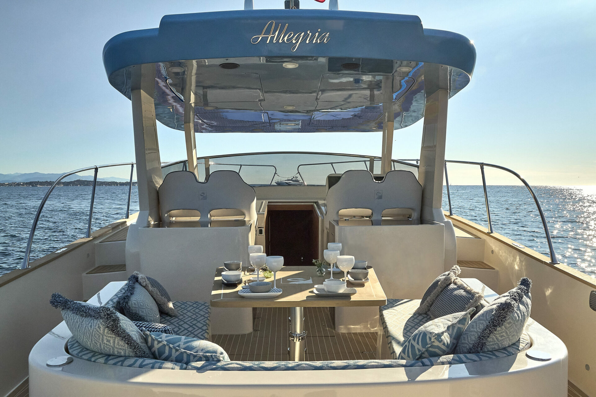 The cockpit laid for a meal, with the Allegria name on the T-top above