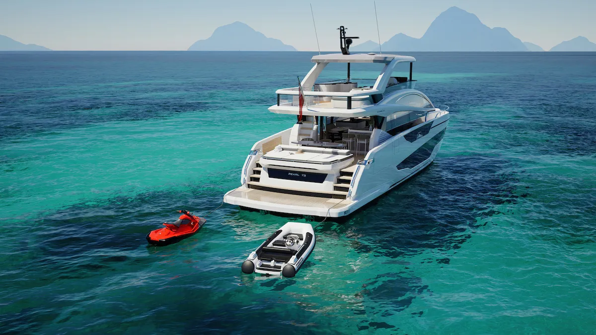 The 73 at anchor with a tender and a jet ski alongside