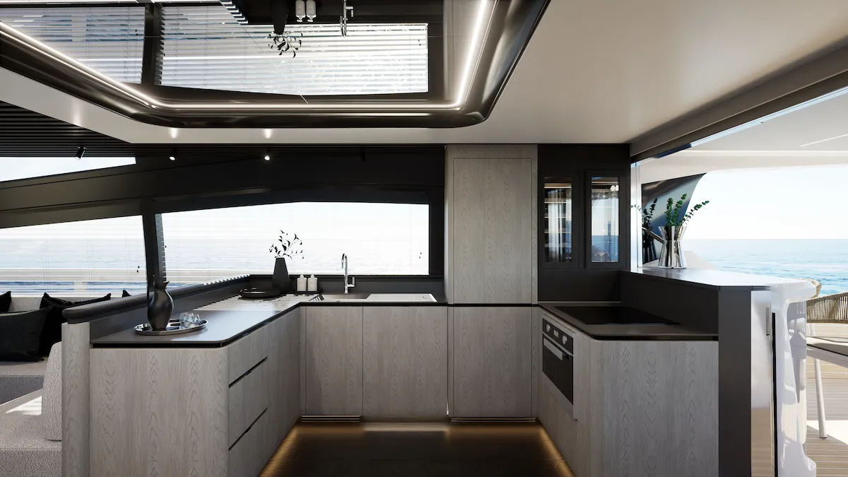 The galley, with an L-shaped counter under a window and blinds above