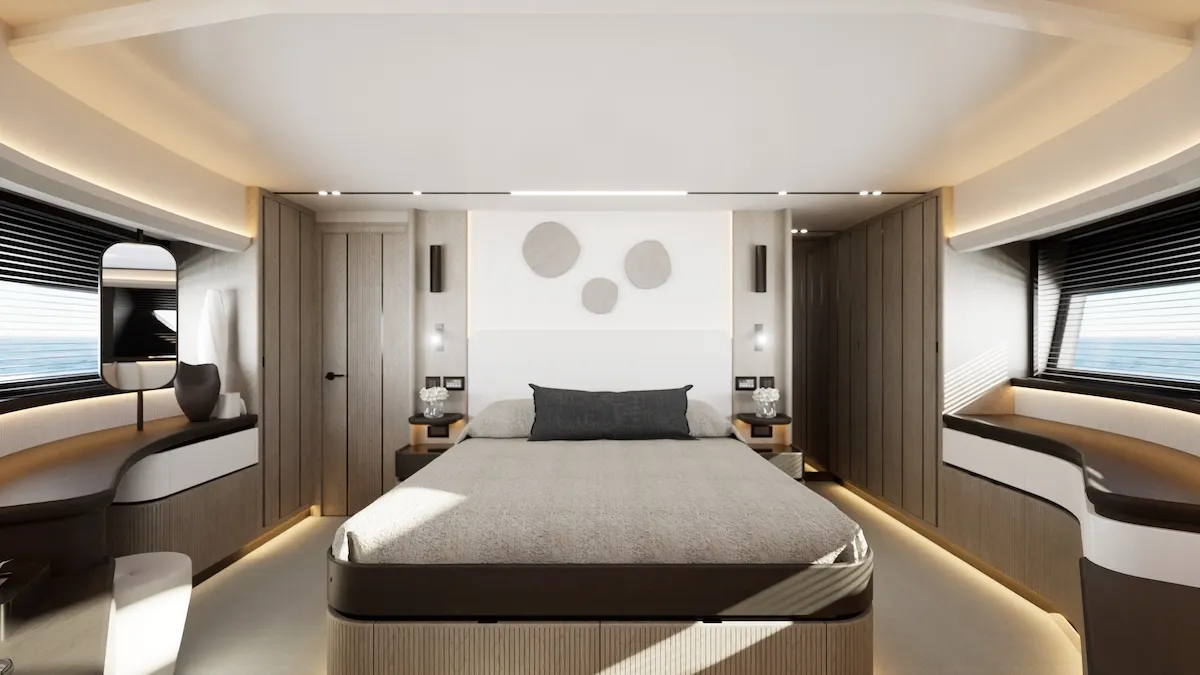 A cabin with a double berth between two bedside tables and a window each side
