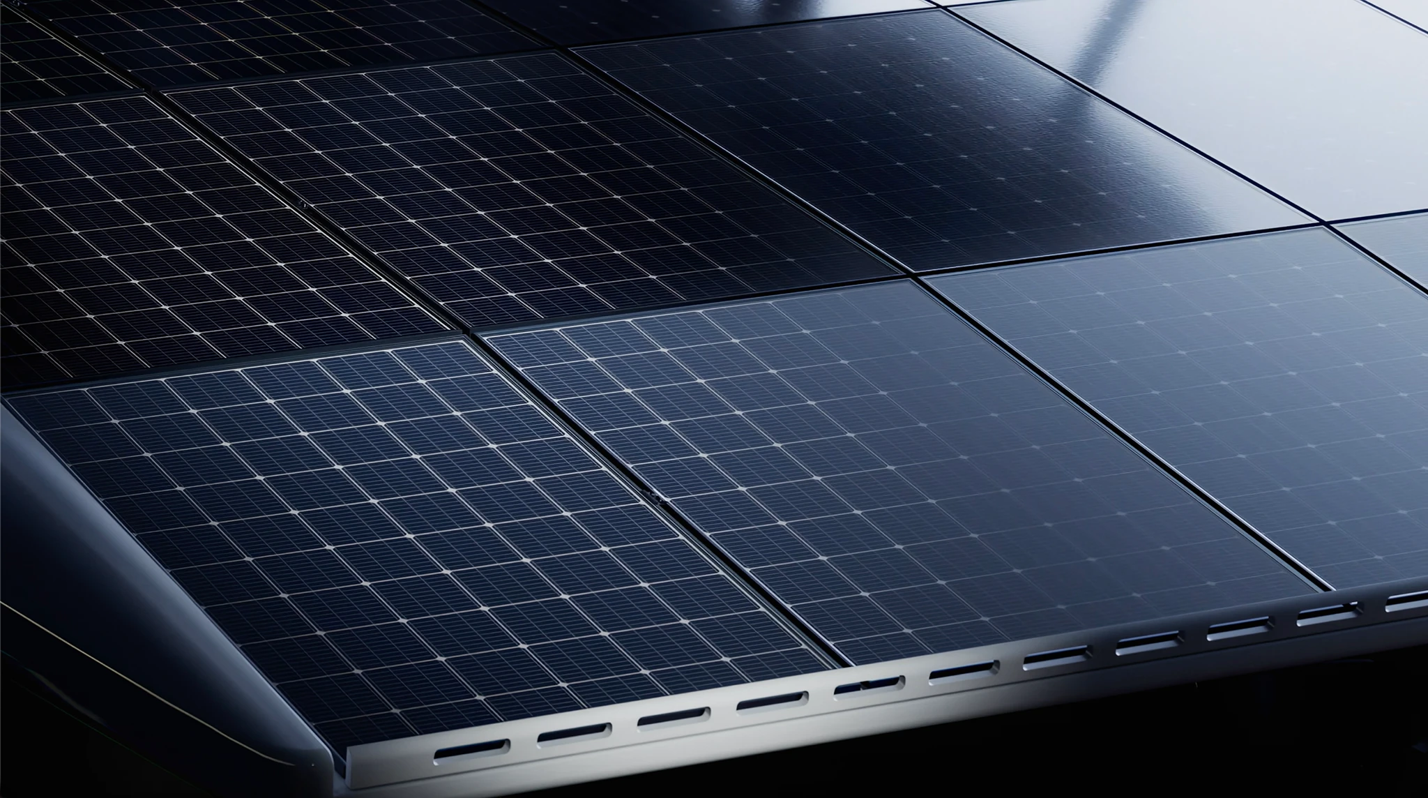 A close view of the solar array on the PY60's roof, dark panels with fine grid lines meeting at a metal edge trim
