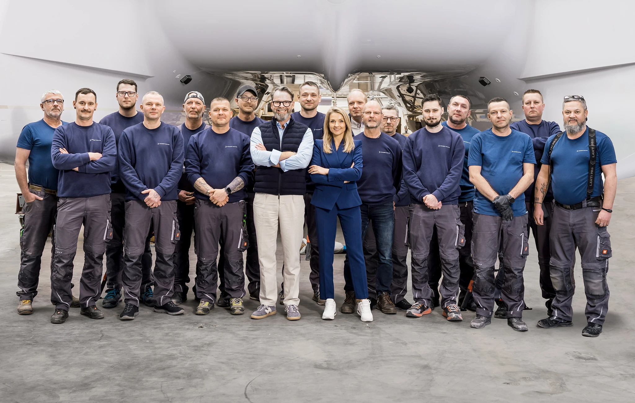 The build team standing in front of the PY60's hull inside the yard in Stralsund