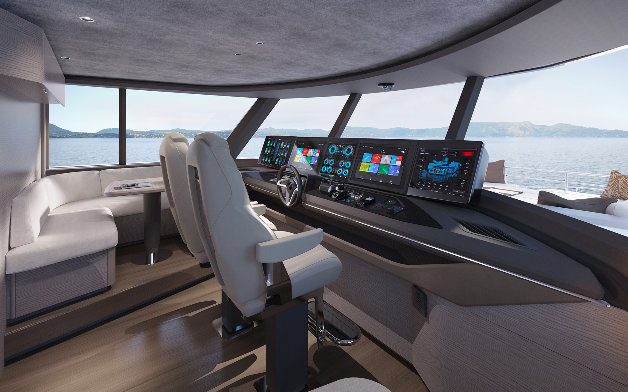 The enclosed helm, two white helm seats before a wide dark console carrying five screens under a curved windscreen, with a settee and table to one side