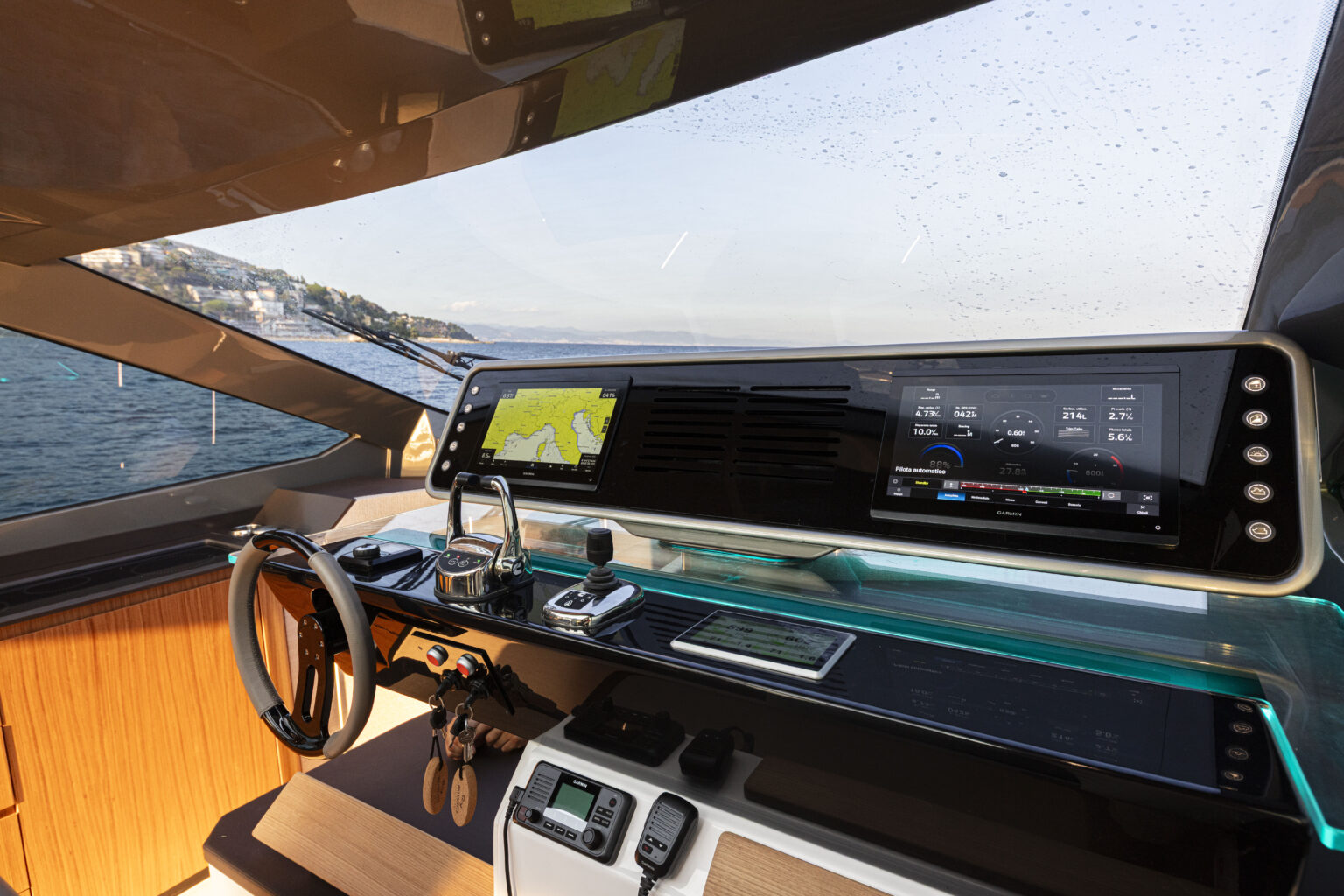 The helm from the side, with a wide curved display and the wheel below it