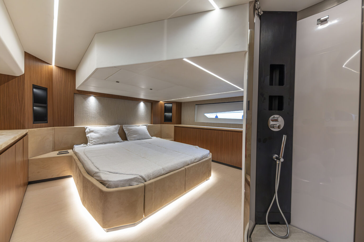A second cabin with a double berth and a shower compartment beyond