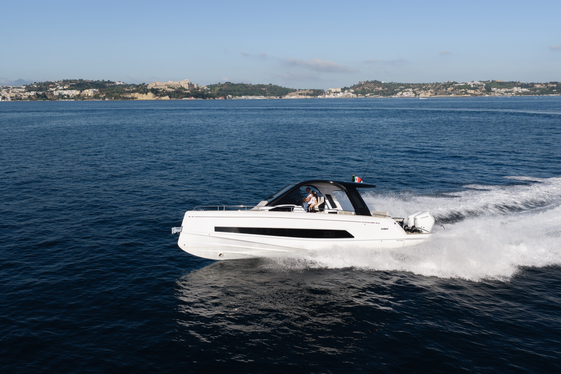 Running at speed in profile, with the long black window along the hull