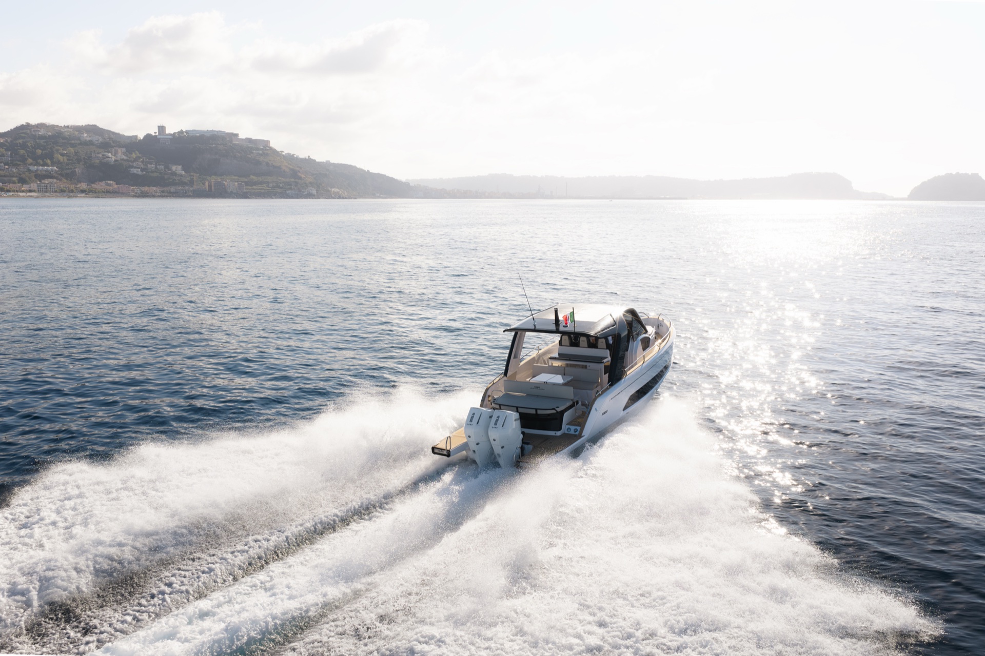 From astern on the port quarter, twin outboards and the aft cockpit