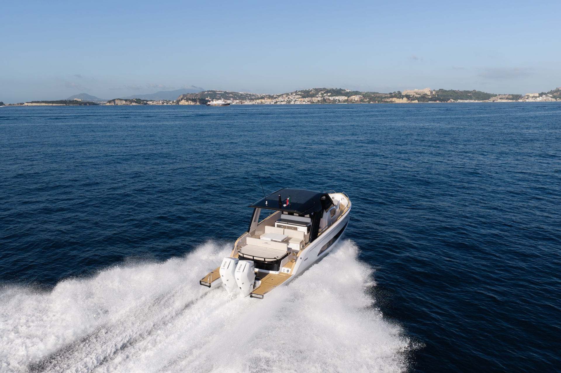 From above and astern in a turn, looking down into the cockpit and swim platform