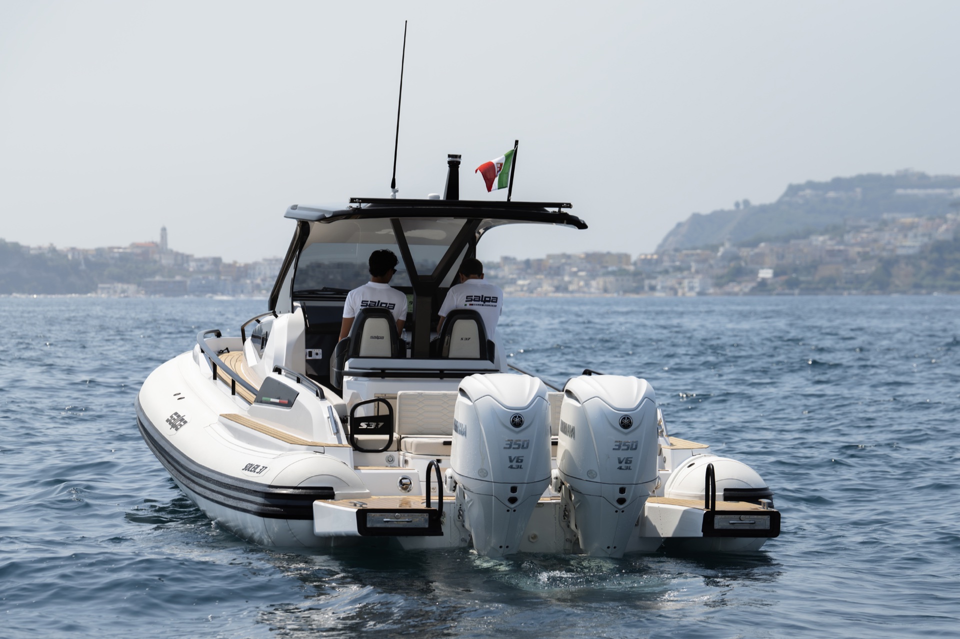 The stern of the Soleil 37 at rest, twin outboards, the swim platforms either side and the helm seats under the T-top