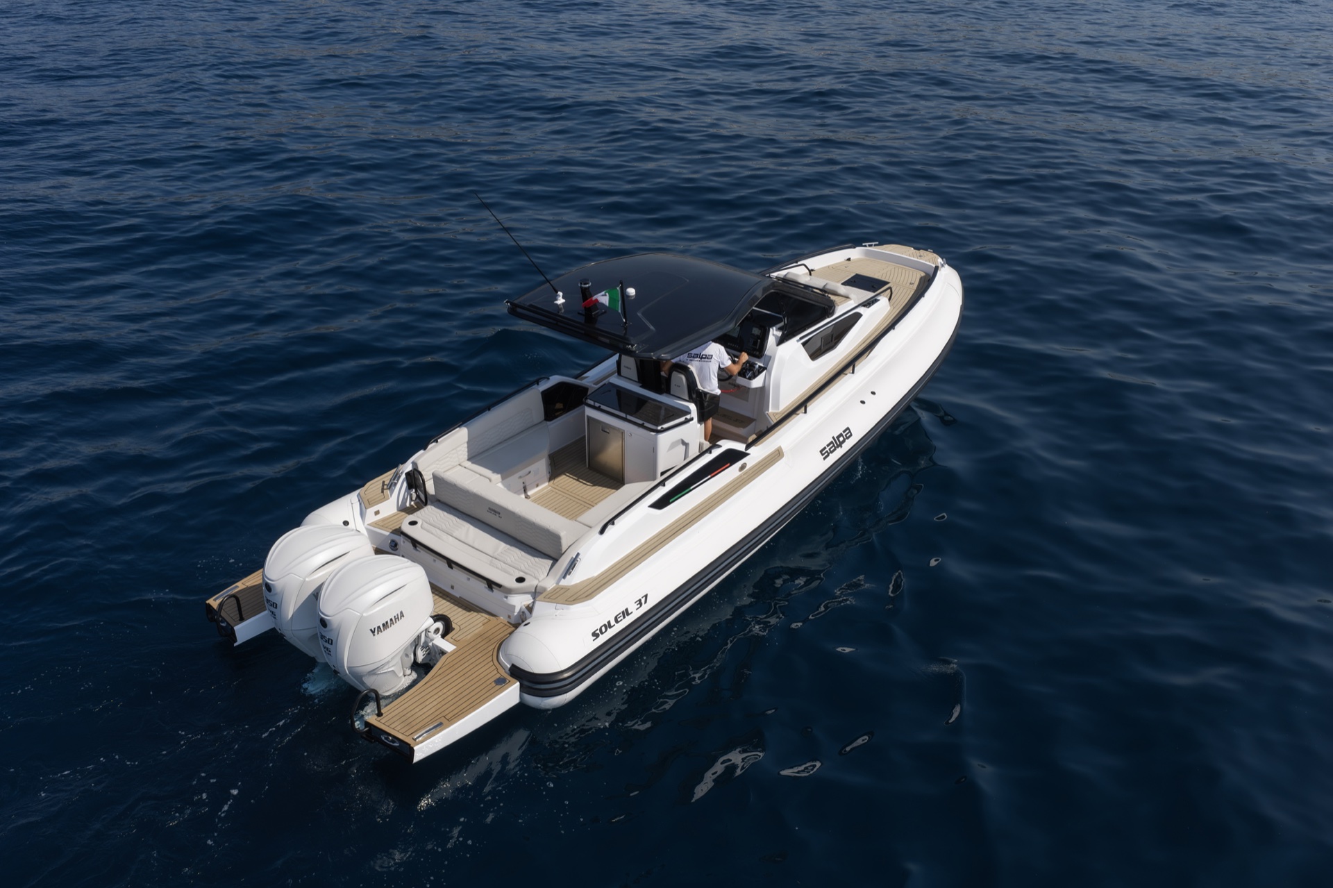 The Soleil 37 from above at rest, looking forward over the aft platform, twin outboards and the cockpit seating
