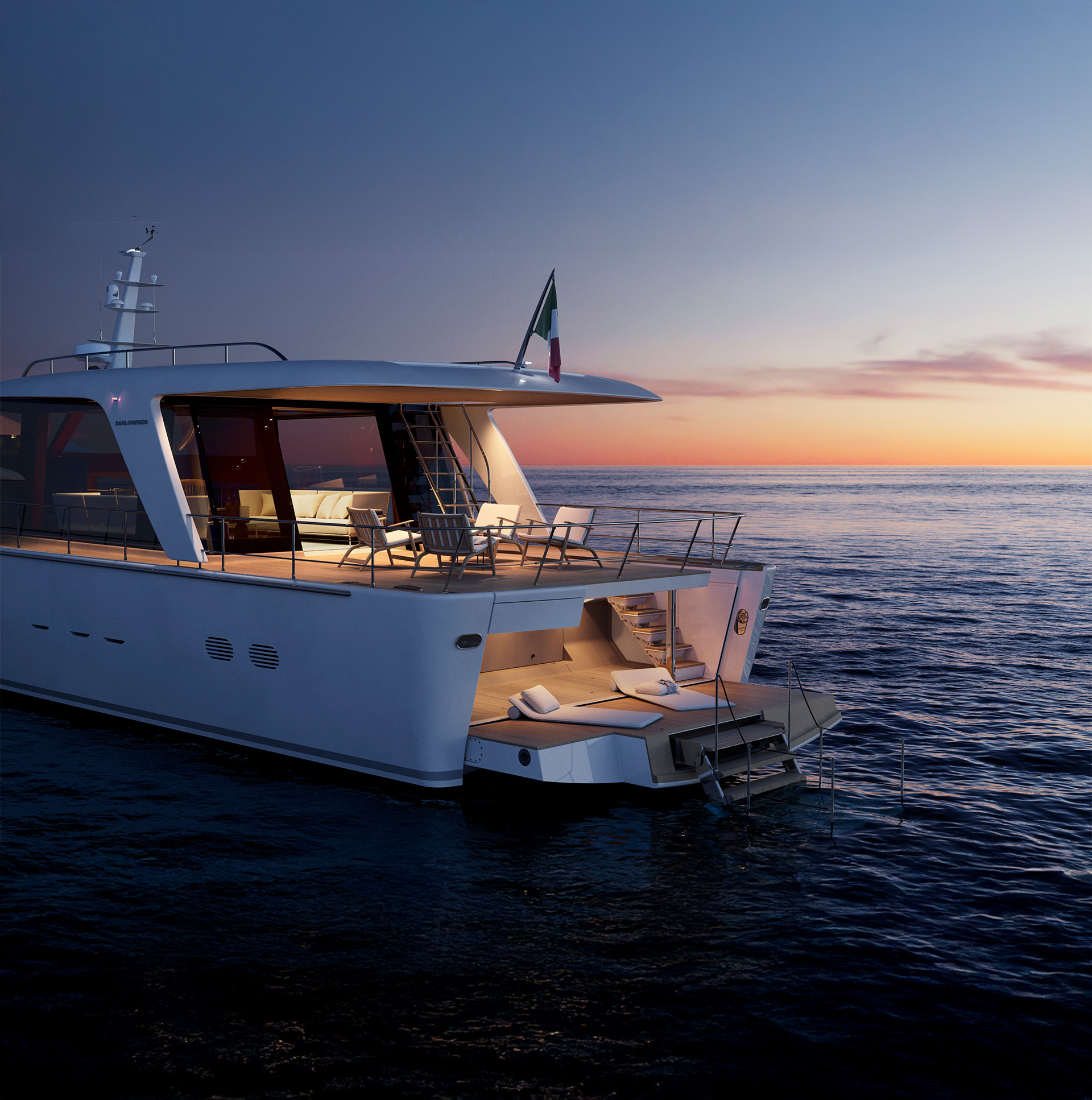 SHE at anchor at sunset, the aft deck lit from within
