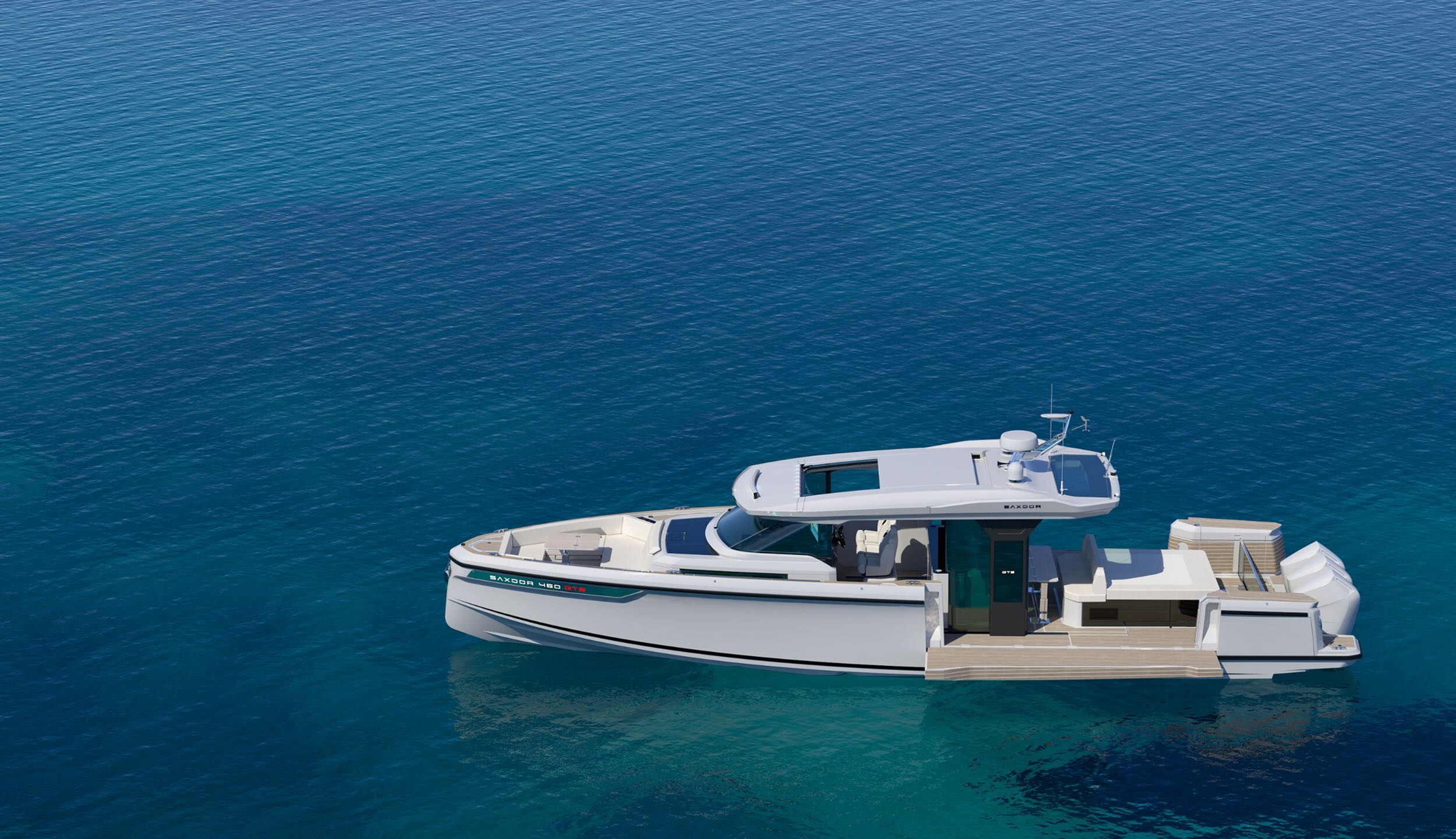The 460 GTS lying still on turquoise water, seen from above and abeam