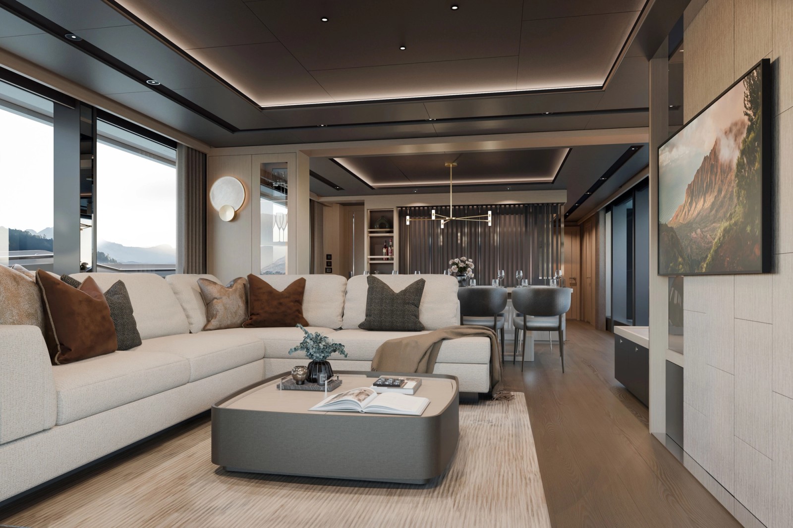 The saloon looking forward: an L-shaped cream sofa around a low table on a pale rug, the dining table and chairs beyond it, and full-height windows down one side