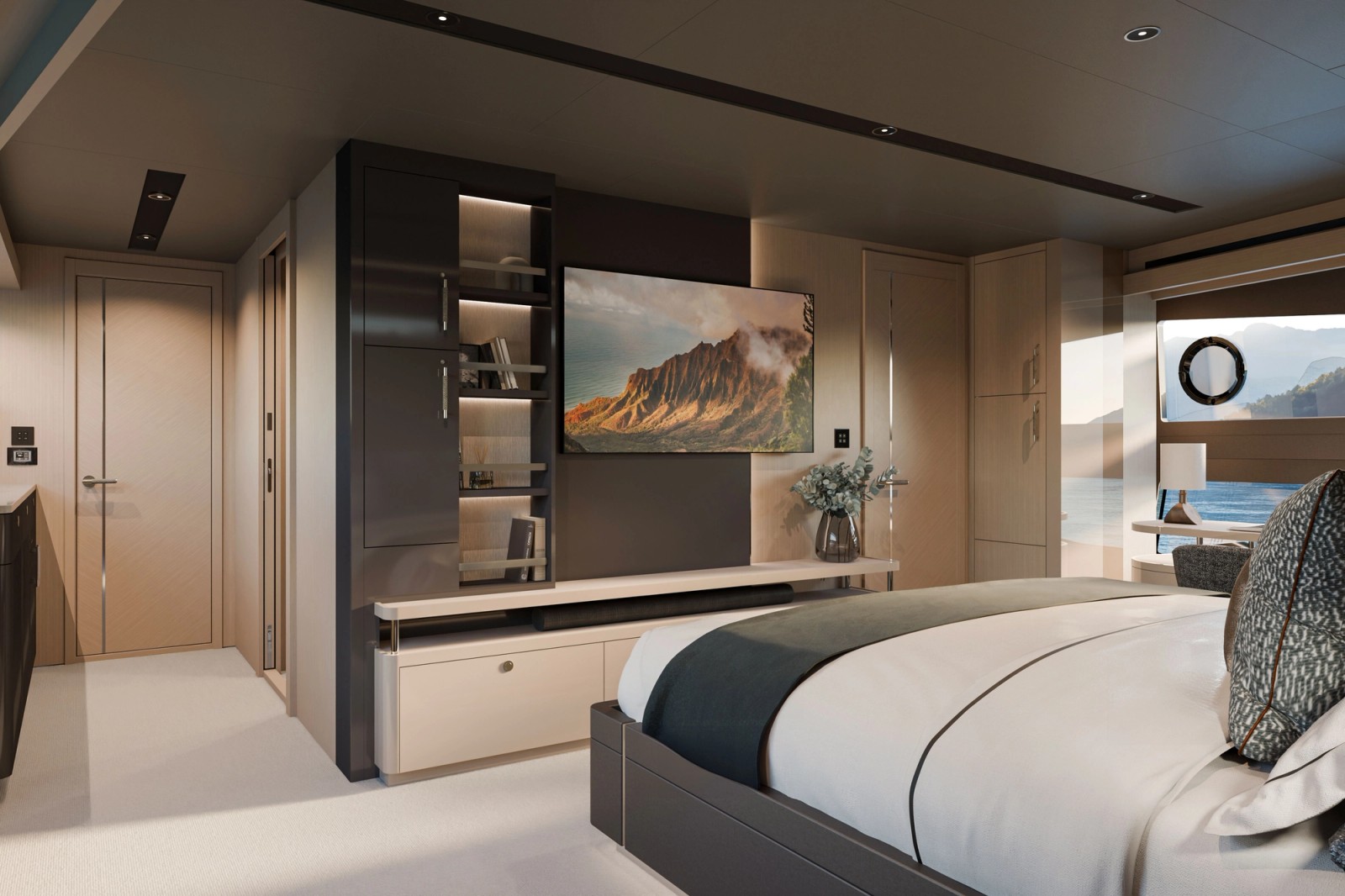 A double cabin seen from the foot of the bed, with a television set into a panelled wall, open shelving lit beside it and a hull window to the right