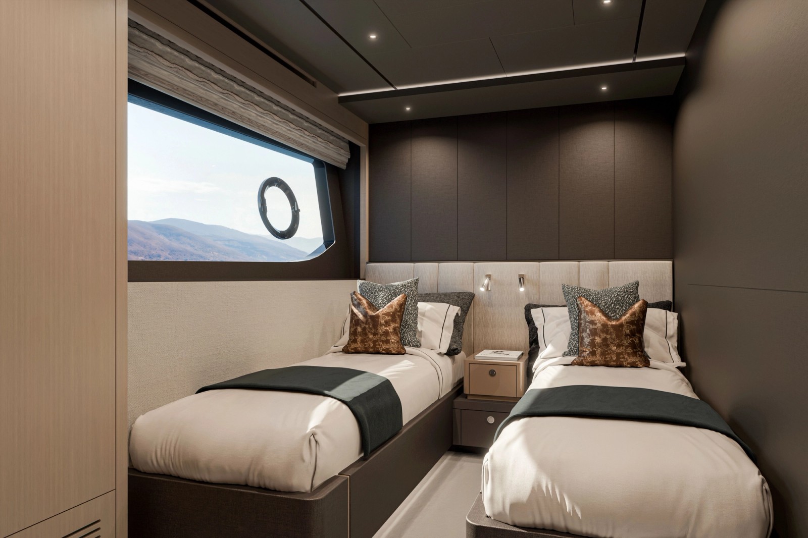 A guest cabin with two single beds either side of a bedside cabinet, and a hull window with a blind above the left-hand bed