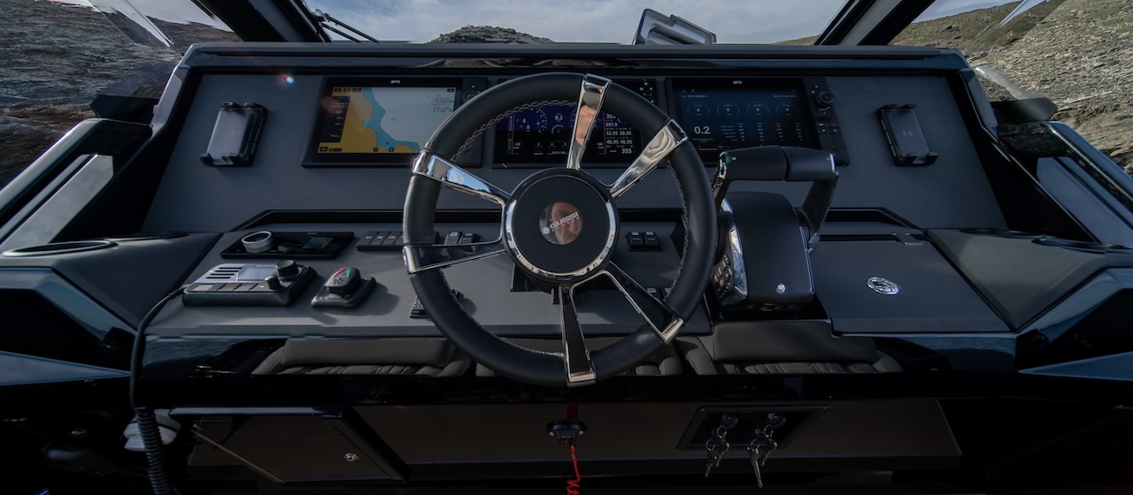 The helm, with the steering wheel at the centre of the console between three screens