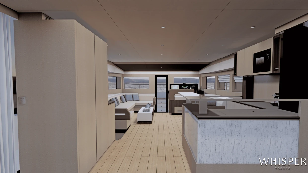 The saloon looking forward, with a galley island and a corridor beyond