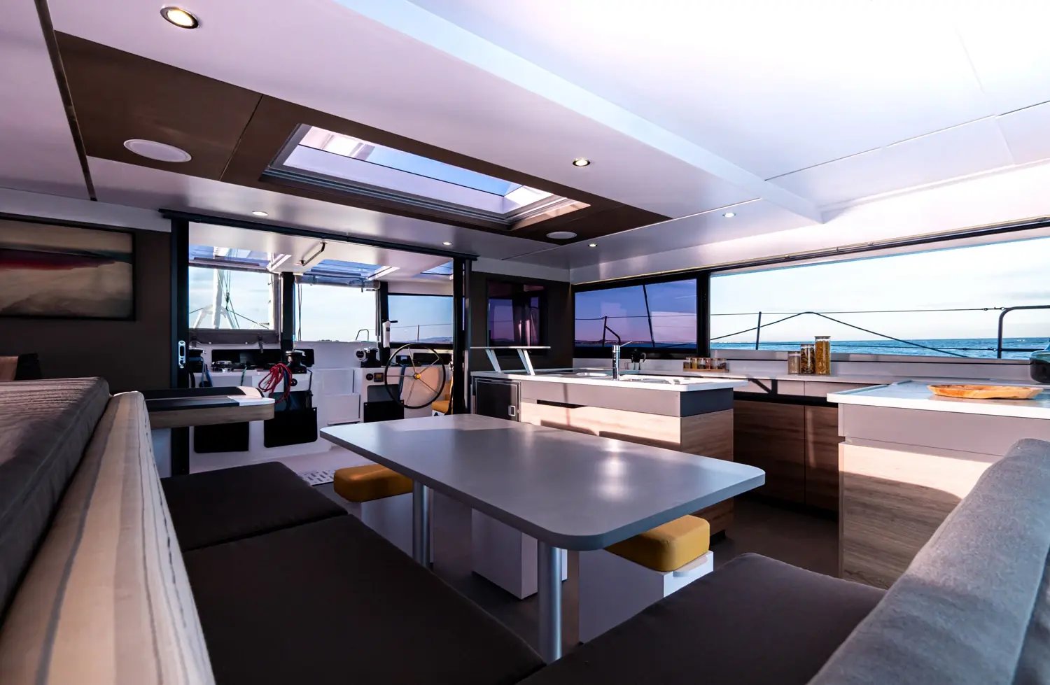 The saloon from the other side, with seating around a table and the galley beyond