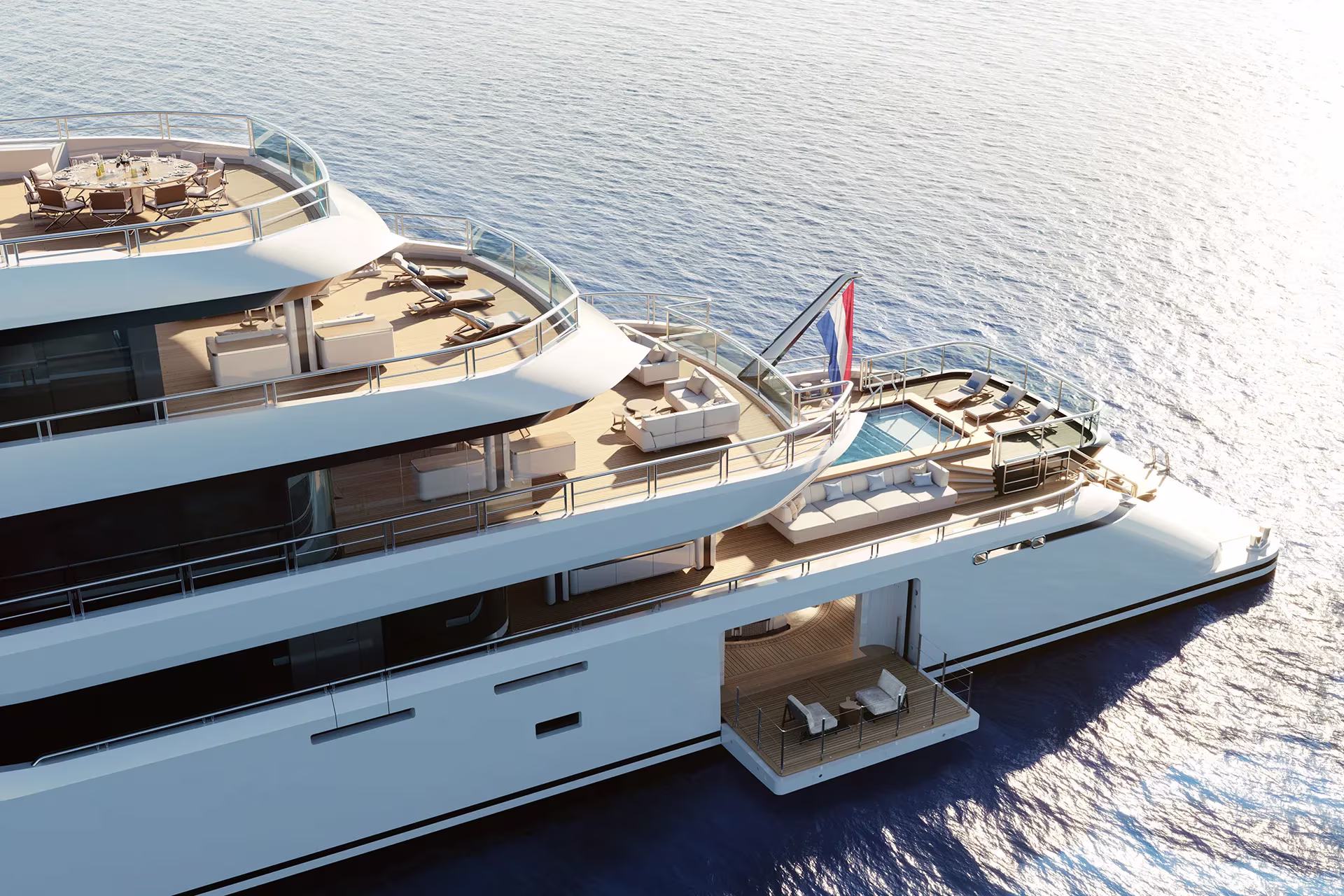 An Amels 80 from above and astern, showing sundeck dining, sun loungers, an aft pool and a side terrace folded open at the waterline