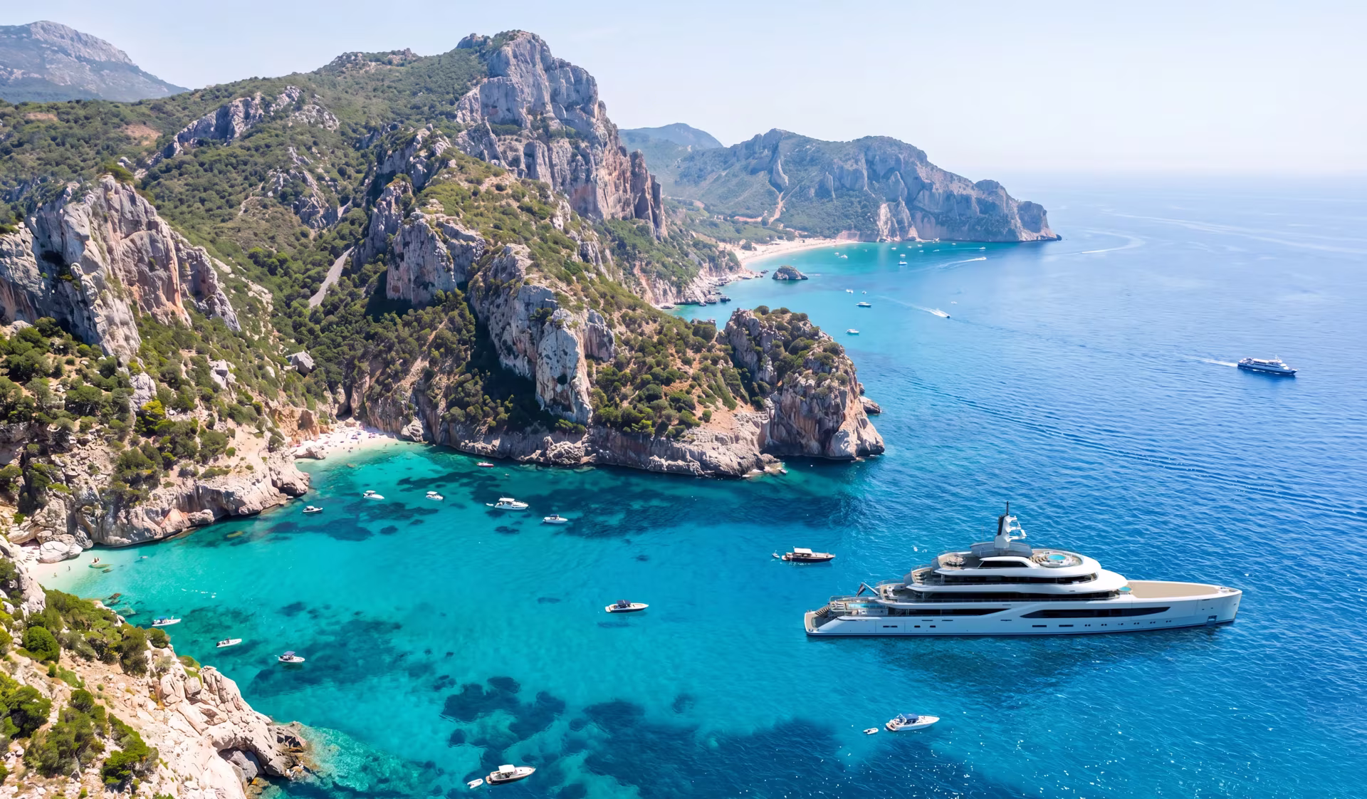 A rendering of an Amels 80 at anchor in a turquoise Mediterranean cove below limestone cliffs, small boats around her