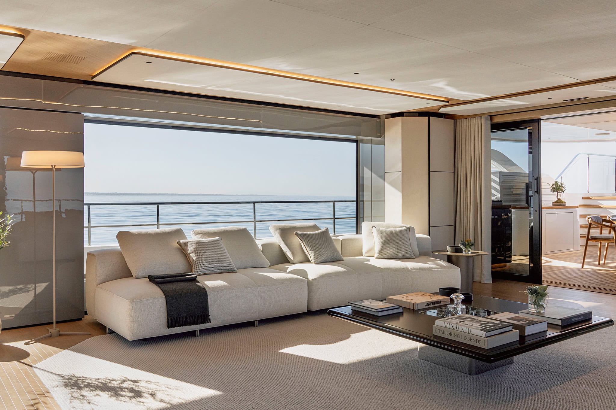 The main salon with the side glazing slid open to the deck