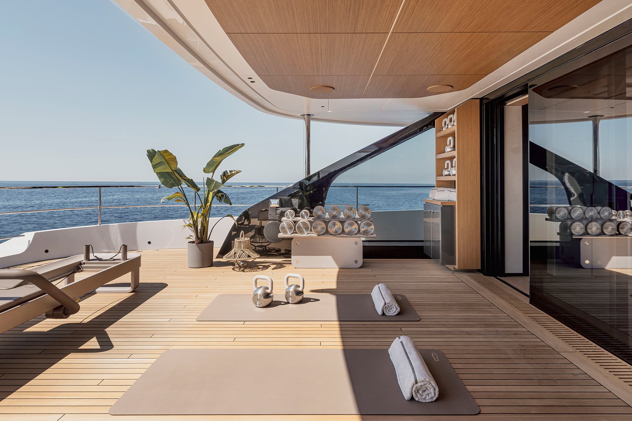 The upper-deck gym, open to the side deck and the sea