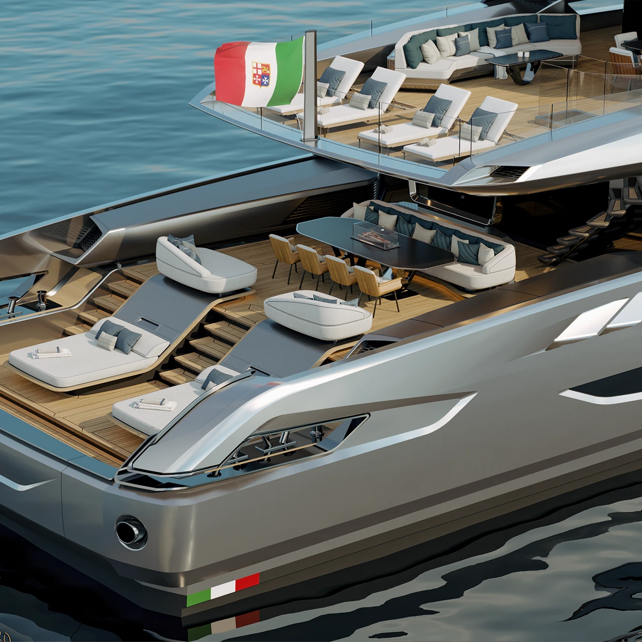 The aft deck with the bulwark folded down, sun loungers and a dining table on teak, and more loungers on the deck above