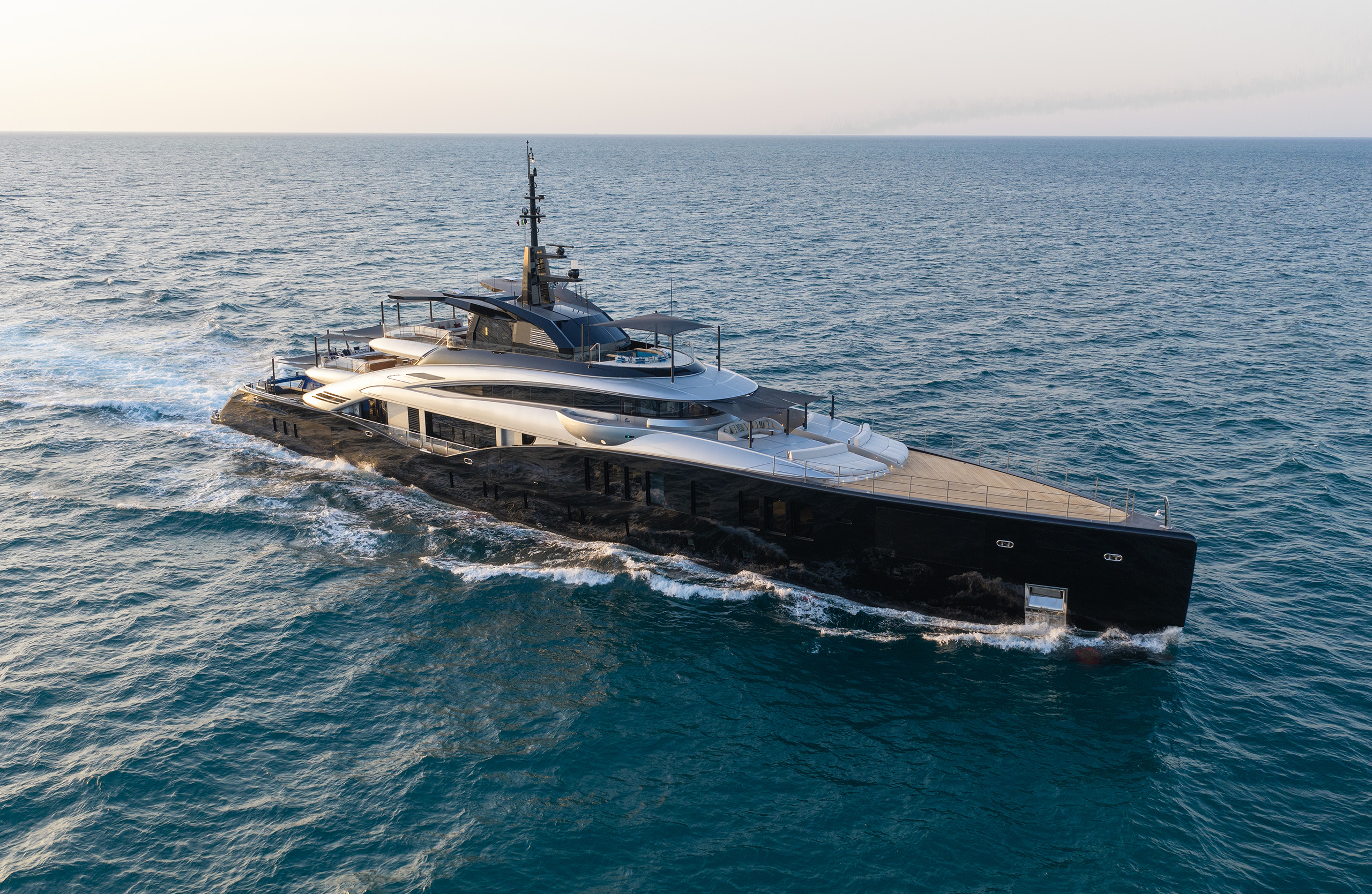An aerial photograph of Sea Raider X from astern and above, showing the sun deck, the spa pool and the long foredeck