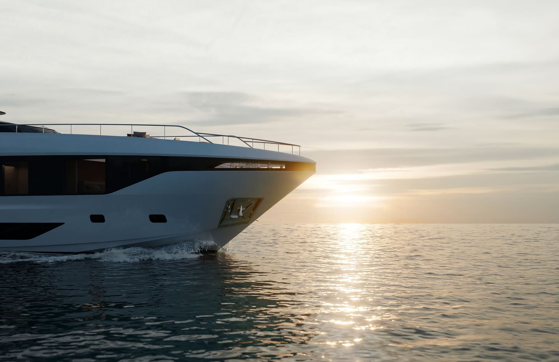 A rendering of the M|38's bow close up against a low sun, a near-plumb stem and the anchor recessed into the hull