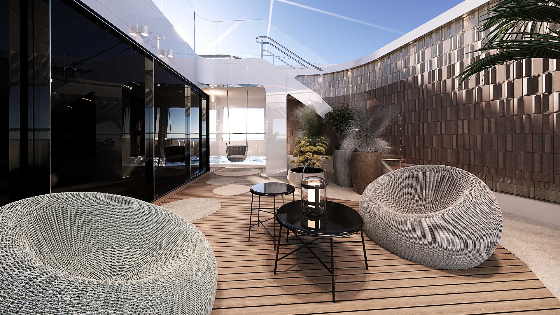 The owner's forward patio, with woven armchairs, planters and a suspended chair against a textured ceramic wall
