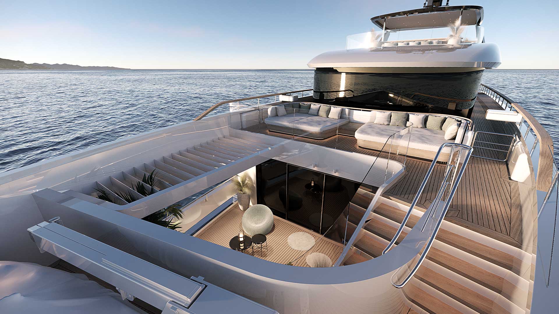 A rendering of the aft decks from above, a sunken lounge, wide steps down to the water and day beds on the deck above