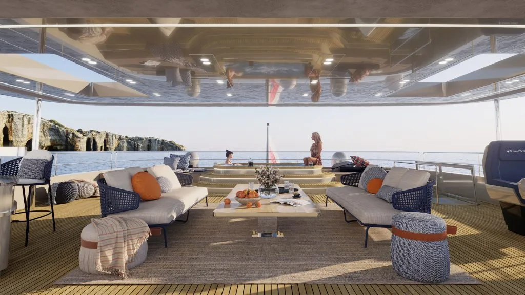 A shaded aft deck with sofas, a low table and a plunge pool beyond, opening to the sea between the hulls